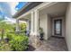 Inviting front porch with brick features, seating, and a beautifully landscaped garden at 6507 Clairborne Ln, Bradenton, FL 34211
