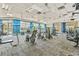 Spacious gym with blue accent wall, high ceilings, multiple machines, and large windows at 6507 Clairborne Ln, Bradenton, FL 34211