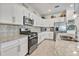 Updated kitchen with stainless steel appliances, granite countertops and mosaic tile backsplash at 6507 Clairborne Ln, Bradenton, FL 34211