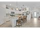 Bright kitchen features white cabinetry, granite counters, stainless appliances, and island with seating at 6507 Clairborne Ln, Bradenton, FL 34211