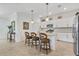 The Kitchen has white cabinets, granite countertops, stainless appliances, and island with barstool seating at 6507 Clairborne Ln, Bradenton, FL 34211