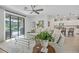 Light-filled living room with comfortable seating, access to the pool, and an open view of the kitchen at 6507 Clairborne Ln, Bradenton, FL 34211