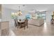An open-concept living space featuring neutral tones, tile flooring, and a charming dining area at 6507 Clairborne Ln, Bradenton, FL 34211