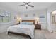 Inviting main bedroom with neutral tones, ceiling fan, and natural light from shuttered windows at 6507 Clairborne Ln, Bradenton, FL 34211