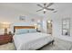 Bright main bedroom boasts a ceiling fan, white walls, and an ensuite bathroom for added convenience at 6507 Clairborne Ln, Bradenton, FL 34211