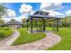 Community park pavilion featuring a picnic table, bike rack, and brick pathway for residents enjoyment at 6507 Clairborne Ln, Bradenton, FL 34211