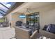 A screened-in patio with comfortable seating, ceiling fan, and outdoor TV at 6507 Clairborne Ln, Bradenton, FL 34211