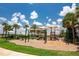 Community playground with swings, slides, and play structures on a mulch surface at 6507 Clairborne Ln, Bradenton, FL 34211