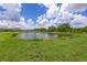 Enjoy the beautiful views of the community pond surrounded by lush green grass at 6507 Clairborne Ln, Bradenton, FL 34211