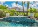 The tranquil pool features a beautiful waterfall with playful frog statues at 6507 Clairborne Ln, Bradenton, FL 34211