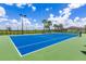 Brightly colored community tennis court surrounded by landscaping and fencing at 6507 Clairborne Ln, Bradenton, FL 34211