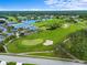 Aerial view of golf course and community amenities, including a tranquil pond at 6507 Stone River Rd # 304, Bradenton, FL 34203