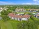 Scenic aerial view of a residential community with golf course, lush greenery, and ponds at 6507 Stone River Rd # 304, Bradenton, FL 34203