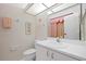Well-lit bathroom with vanity and soft, patterned wallpaper at 6507 Stone River Rd # 304, Bradenton, FL 34203