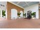 Clubhouse entrance featuring brick facade, white pillars, and covered porch at 6507 Stone River Rd # 304, Bradenton, FL 34203