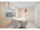 Bright eat-in kitchen featuring a table and chairs, window with blinds, and light striped walls at 6507 Stone River Rd # 304, Bradenton, FL 34203