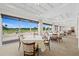 Elegant dining room with large windows offering scenic golf course views, coffered ceilings, and refined decor at 6507 Stone River Rd # 304, Bradenton, FL 34203