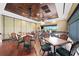 Inviting dining area with wood floors, ceiling fans, and views of the community golf course at 6507 Stone River Rd # 304, Bradenton, FL 34203