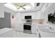 A well-lit kitchen with white cabinets, stainless steel appliances, and a modern design at 6507 Stone River Rd # 304, Bradenton, FL 34203