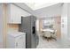 Bright eat-in kitchen with stainless steel refrigerator and table with chairs, with a bright window at 6507 Stone River Rd # 304, Bradenton, FL 34203
