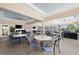 Relaxing outdoor patio seating with ceiling fans, string lights, and views of the pool area at 6507 Stone River Rd # 304, Bradenton, FL 34203