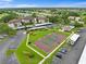 Aerial view of tennis courts surrounded by lush landscaping and community buildings at 6507 Stone River Rd # 304, Bradenton, FL 34203