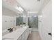 Contemporary bathroom with double vanity, modern fixtures, and a glass-enclosed shower for a spa-like experience at 6563 Silverstar Dr, Sarasota, FL 34240