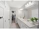 Well-lit bathroom with double sink vanity, ample cabinet space, and stylish mirror at 6563 Silverstar Dr, Sarasota, FL 34240