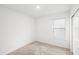 Bright bedroom with neutral carpet and walls, featuring a window and closet at 6563 Silverstar Dr, Sarasota, FL 34240