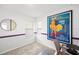 A bedroom with a large art piece on the wall, as well as a desk for work or study at 6563 Silverstar Dr, Sarasota, FL 34240