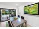 Bright dining area featuring a glass table with seating, with a view of the pool and outdoor lounge area at 6563 Silverstar Dr, Sarasota, FL 34240