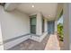 Covered front porch with stone pavers, a modern front door, and neutral accents at 6563 Silverstar Dr, Sarasota, FL 34240