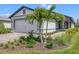 Charming single-story home featuring a manicured lawn and tropical landscaping at 6563 Silverstar Dr, Sarasota, FL 34240