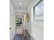 Bright hallway showcasing modern decor and a view of the outdoor living space at 6563 Silverstar Dr, Sarasota, FL 34240