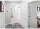 Hallway featuring white wall treatments and leading to bedrooms at 6563 Silverstar Dr, Sarasota, FL 34240