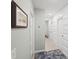 Long hallway with decorative wall paneling, neutral tones, and stylish doors leading to various rooms at 6563 Silverstar Dr, Sarasota, FL 34240