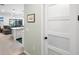 Hallway leads to a modern kitchen and living area, providing a bright and open floor plan at 6563 Silverstar Dr, Sarasota, FL 34240