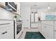 Modern kitchen with white cabinets, stainless steel appliances, and stylish tile backsplash at 6563 Silverstar Dr, Sarasota, FL 34240