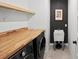 Modern laundry room featuring wood countertops, washer, dryer and sink at 6563 Silverstar Dr, Sarasota, FL 34240