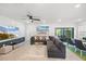Bright and airy living room featuring a comfortable sectional sofa and access to the outdoor area at 6563 Silverstar Dr, Sarasota, FL 34240
