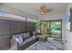 Screened-in patio with comfortable seating, a ceiling fan, and views of the pool at 6563 Silverstar Dr, Sarasota, FL 34240