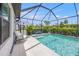 Lush landscaping surrounds the screened pool at 6563 Silverstar Dr, Sarasota, FL 34240