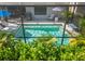 Inviting screened-in pool with sun loungers and umbrella providing a relaxing outdoor space at 6563 Silverstar Dr, Sarasota, FL 34240