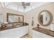 Well-lit bathroom featuring granite countertops, dual mirrors, and modern fixtures at 6832 Woodwind Dr # 53, Sarasota, FL 34231