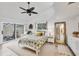 Light-filled bedroom with vaulted ceiling, ceiling fan, sliding glass doors, and neutral decor at 6832 Woodwind Dr # 53, Sarasota, FL 34231