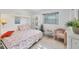 Charming bedroom with a comfortable bed, decorative pillows, and a sunny window view at 6832 Woodwind Dr # 53, Sarasota, FL 34231
