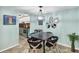 Modern dining area with stylish black table and chairs, unique mirror decor, and elegant lighting at 6832 Woodwind Dr # 53, Sarasota, FL 34231