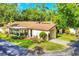 Attractive home exterior featuring a carport, enclosed porch, and neatly maintained landscaping at 6832 Woodwind Dr # 53, Sarasota, FL 34231