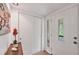Bright foyer with white walls, tile floor, coat closet, and frosted glass front door at 6832 Woodwind Dr # 53, Sarasota, FL 34231