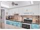 Well-appointed kitchen with stainless steel appliances, white cabinetry, and blue accents at 6832 Woodwind Dr # 53, Sarasota, FL 34231
